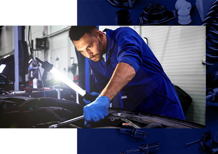 Technician performing repair work in blue coveralls